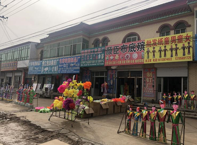 仅1公里多的街道上,就有超过500家的殡葬用品批发商,产品覆盖寿衣